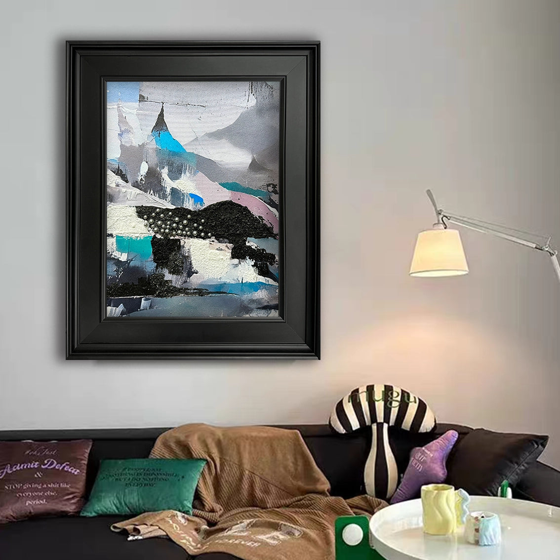 Abstract wall art with heavy texture and pearl inlay adding artistic style to a cozy living room.