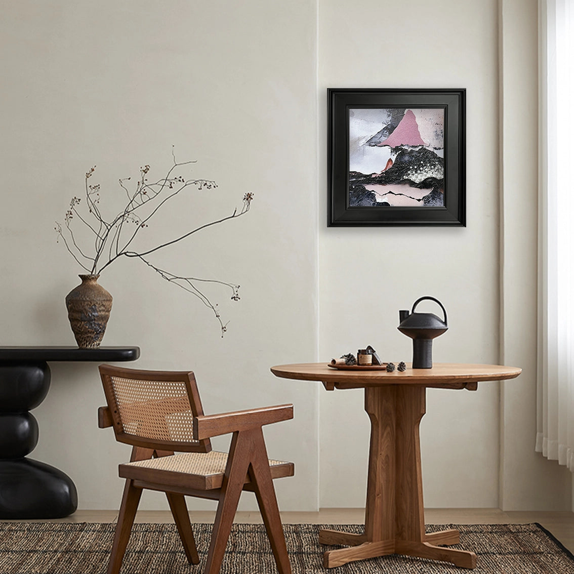 Abstract textured wall art with pearl inlay displayed in a minimalist dining or reading corner.