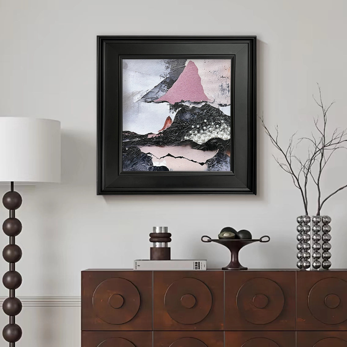Abstract textured wall art with pearl inlay in a modern living room, elegant black frame decor.