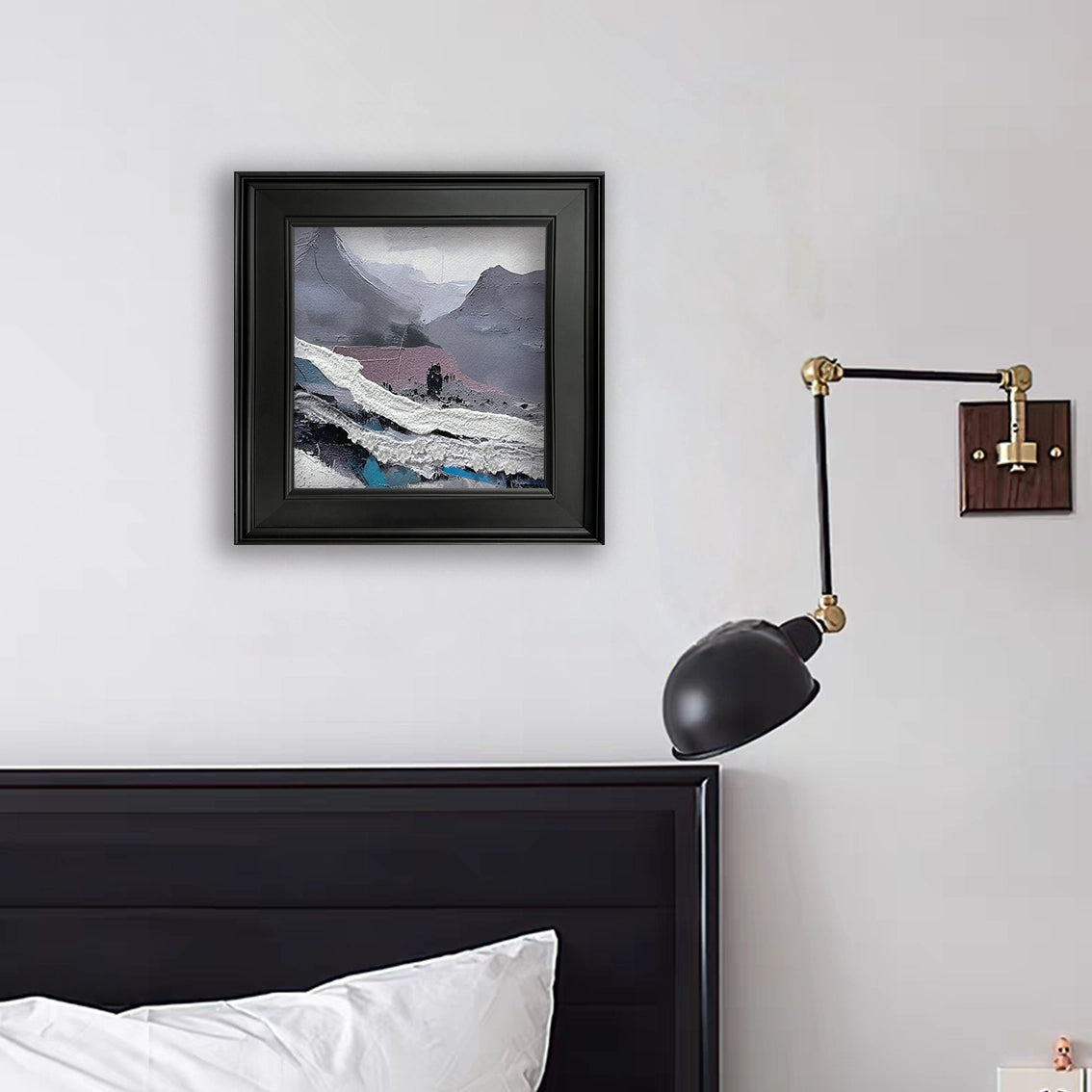 Textured abstract mountain wall art with relief details styled in a minimal bedroom setting.